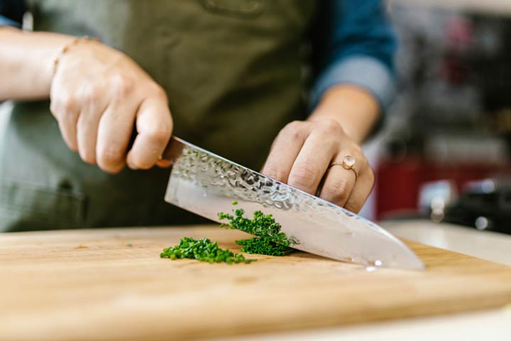 Cuchillo cebollero cortando sobre una tabla
